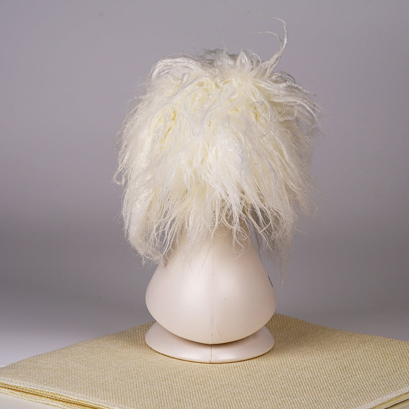 A white synthetic fiber dog wig displayed on a mannequin head, resembling a fluffy dog with black eyes and a pink collar.