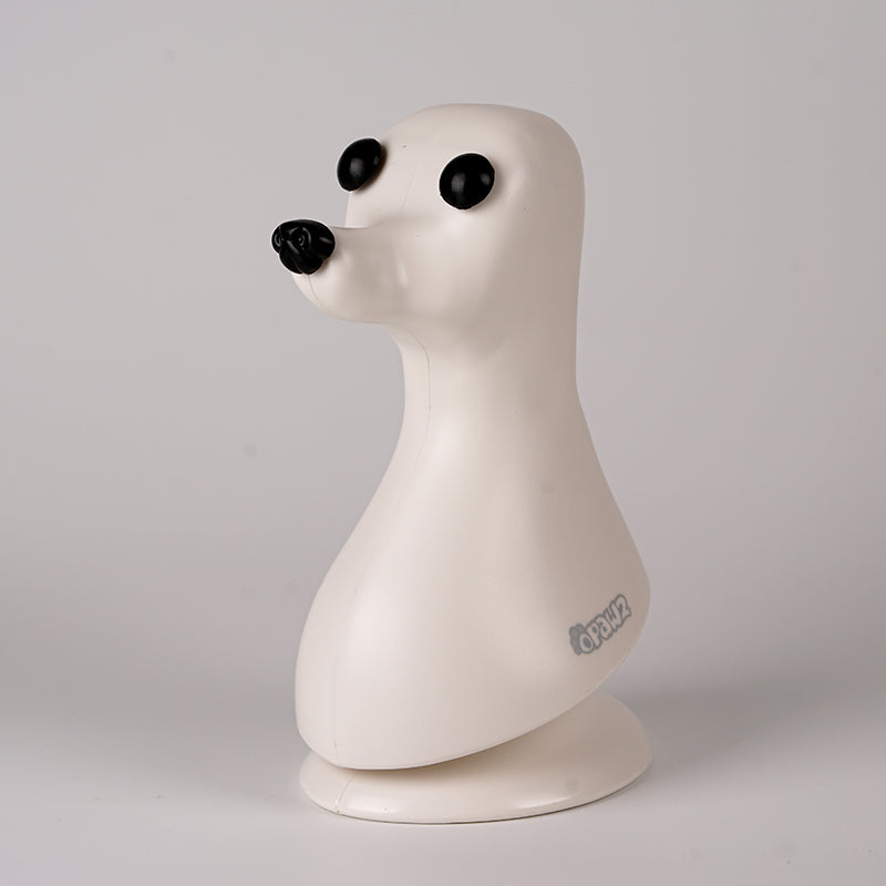 A plastic model of a dog head, designed in a teddybear style with black eyes, on a plain background.