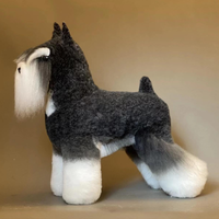 A synthetic fiber dog wig designed to resemble a Schnauzer, in white, black, and grey colors, displayed on a mannequin dog stand.