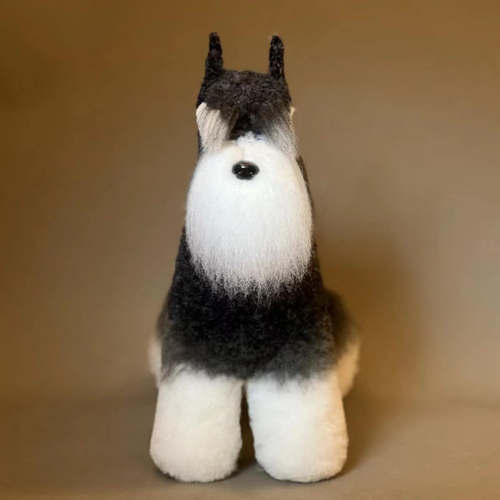 A synthetic fiber dog wig designed to resemble a Schnauzer, in white, black, and grey colors, displayed on a mannequin dog stand.
