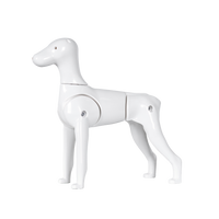 A white plastic model of a Schnauzer dog with moveable tail and legs.