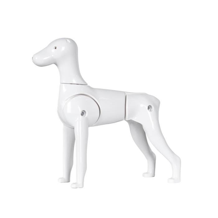 A white plastic model of a Schnauzer dog with moveable tail and legs.