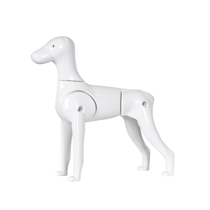 A white plastic model of a Schnauzer dog with moveable tail and legs.