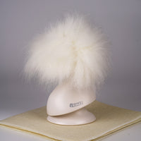 A white synthetic fiber dog wig displayed on a mannequin head, resembling a fluffy dog with black eyes and a pink collar.